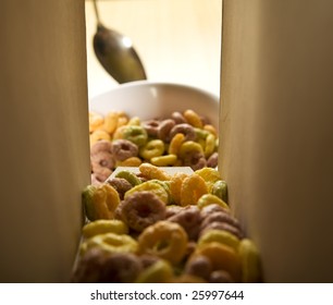 Cereal Loops Pouring Out Of The Carton Box Into A Bowl