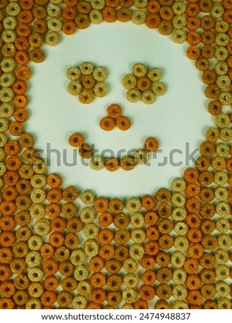 Cereal, Multigrain hoops, background texture. Brown colours behind a white background. 'happy hoops' smiley face. Colorful cereal pattern with space for text. High-key lighting. 