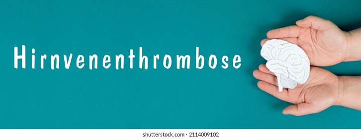 Cerebral Vein Thrombosis Is Standing In German Language On A Background, Silhouette Of A Head With A Brain, Red Blood Clot, Side Effect Covid-19 Vaccine