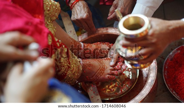 A ceremony of washing feet to the bride before her\
marriage by her female relatives, Nepali and Hindu ritual,\
tradition, culture, religious, Brahmin cast system, wedding day in\
Nepal, India