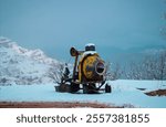 Certainly! A stunning winter scene featuring a drum mixer positioned on a snow-covered mountain, surrounded by pristine white snow and serene, icy landscapes under a clear, crisp sky.

