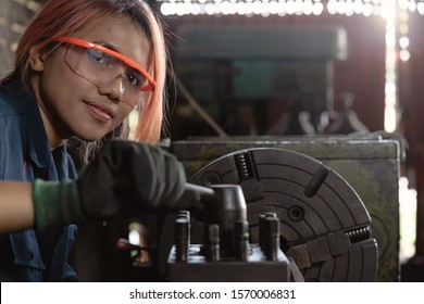 Certified industry female mechanical engineer working on industrial factory machinery - Skilled apprentice technician woman wearing safety equipment - Training, repair and diversity at work concept - Powered by Shutterstock