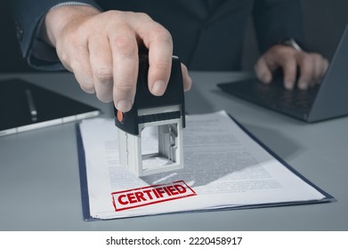 certified stamp on document. businessman approve and certificate concept, confirmation of business marketing document permit and certified stamping. Person Hand Stamping With certified Stamp