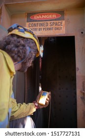 Certified Trained Competent Personnel Holding Gas Test Detector Conducting Gas Leak Testing Atmosphere Particle At Confined Space Manhole Entry Door Making Sure Is Safe Prior To Enter Working Inside  