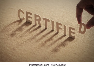 CERTIFIED Wood Word On Compressed Or Corkboard With Human's Finger At D Letter.
