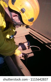 Certifies Construction Miner Officer Conducting Gas Testing Detector Atmosphere Inside The Confined Space Chute At The Entry Point Mining Site Pilbara Region, Perth Western  Of Australia 