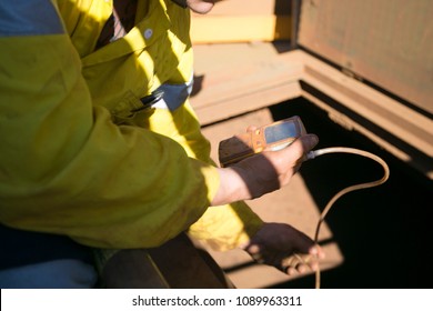 Certifies Miner Officer Wearing Yellow Long Sleeve Shirt Commencing Conducting Gas Testing Atmosphere Inside The Confined Space Chute At Mining Site Pilbara Region, Perth Western  Of Australia