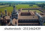 Certosa di Pavia seen from an aerial view, Italian wonders and art, historical monumental complex that includes a monastery and a sanctuary. green court and a church. Pavia, Italy