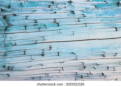 Cerulean Teal Colored Close Up Texture Of Cracked And Weathered Old Old Telephone Pole With Rusted Staples And Nails