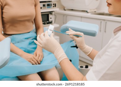 Cervical cells are applied to a microscope slide for examination. A Pap smear sample on a slide for testing. Gynecologist prepares a cytology slide using a sterile brush
