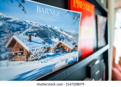 CERVO Hotel, Zermatt, Switzerland. March 15, 2022. Snow Covered Houses With Text On Postcard. Beautiful Paper Is On Wooden Shelf. It Is Decorated In Hotel Room Of Luxurious Ski Resort.