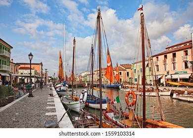 Cesenatico, Emilia Romagna, Italy - August 22, 2019: the port canal designed by Leonardo da Vinci in the ancient city on the Adriatic sea coast with the ancient wooden sailing boats 


