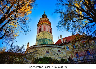 Cesky Krumlov Castle Tower, Cesky Krumlov, Czech Republic In autumn, the yellow of the leaves contrasts with the blue of the sky