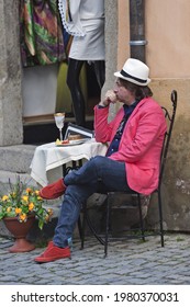 Cesky Krumlov, Czech Republic - September 10, 2014: Fashionably Dressed Man Eating Breakfast Alone At A Table On The Street 