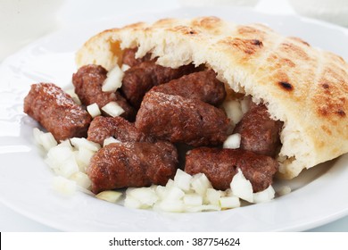Cevapcici, bosnian minced meat kebab served with onion and somun bread