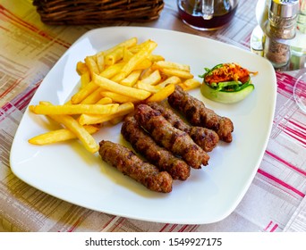 Cevapi - grilled dish of minced meat with french fries. Balkan cuisine