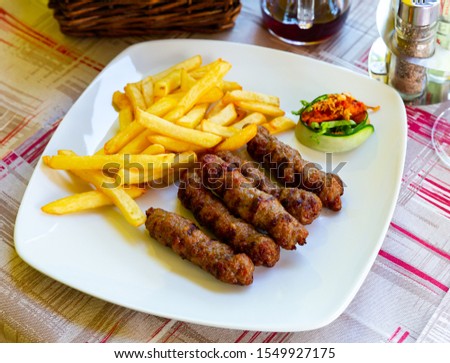 Cevapi - grilled dish of minced meat with french fries. Balkan cuisine
