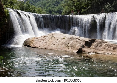 Cevennes France. The river Vis waterfall in full flow into a shallow rocky river in the  Occitanie region. Tributary of the Herault.