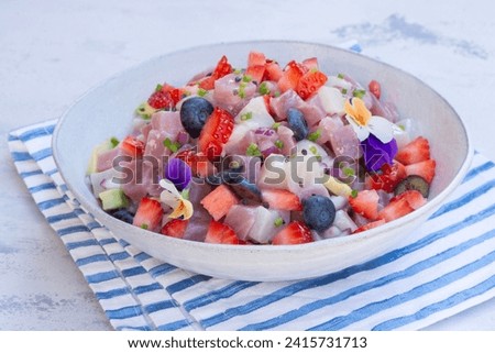 Ceviche dish - appetizer of fresh Tuna fish and Frigate Tuna marinated in citrus with Avocado, red onion Strawberries and Bluebrries