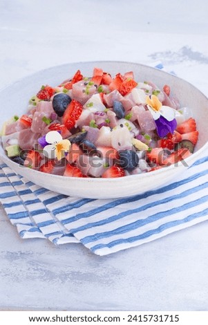 Ceviche dish - appetizer of fresh Tuna fish and Frigate Tuna marinated in citrus with Avocado, red onion Strawberries and Bluebrries