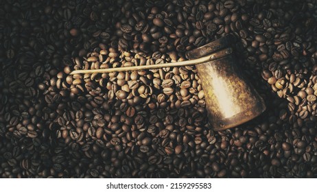 Cezve on coffee beans background