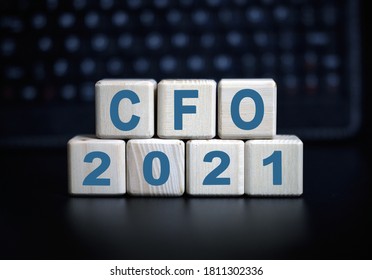 CFO - text in 2021 concept. Wooden cubes on a black keyboard