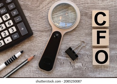 CFO. Wooden Cubes On A Wooden Background. Three Wood Blocks