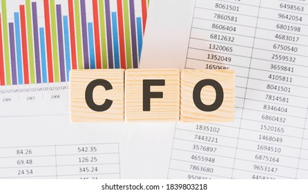 cfo word written on wood block. Faqs text on table, concept.
