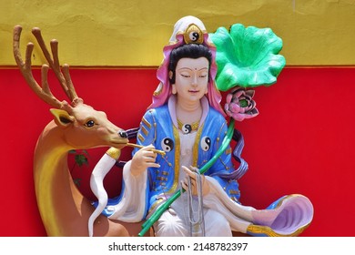 CHACHOENGSAO, THAILAND – APRIL 16, 2022: Statue of a Chinese god or Buddhist saint sitting on a deer at Wat Saman Rattanaram temple in Chachoengsao province of Thailand.
