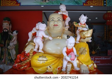 CHACHOENGSAO, THAILAND – AUGUST 29, 2021: A Chinese god statue or Buddhist saint on the base at Wat Saman Rattanaram temple in Chachoengsao province of Thailand.