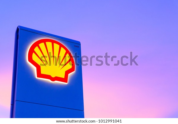 Chachoengsao, Thailand - Jan 28, 2018: Shell gas\
station logo with blue sky background during sunset. Royal Dutch\
Shell sold its Australian Shell retail operations to Dutch company\
Vitol in 2014