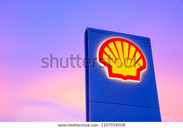 Chachoengsao, Thailand - Jan 28, 2018: Shell gas\
station logo with blue sky background during sunset. Royal Dutch\
Shell sold its Australian Shell retail operations to Dutch company\
Vitol in 2014