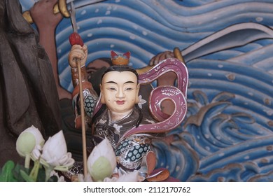 CHACHOENGSAO, THAILAND – JANUARY 23, 2022: A Chinese god statue standing in shrine for selective focus at Wat Saman Rattanaram temple in Chachoengsao province of Thailand.