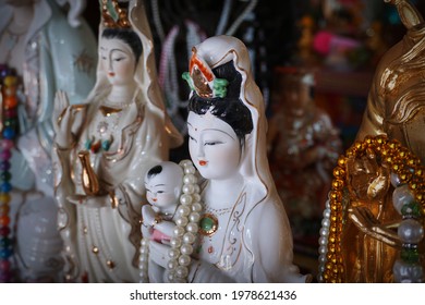 CHACHOENGSAO, THAILAND – MAY 23, 2021: A statue of the Lady Buddha or Guan Im standing at shrine with selective focus in Wat Saman Rattanaram Temple in Chachoengsao province of Thailand.