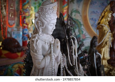 CHACHOENGSAO, THAILAND – MAY 23, 2021: A statue of the Lady Buddha or Guan Im standing at shrine with selective focus in Wat Saman Rattanaram Temple in Chachoengsao province of Thailand.