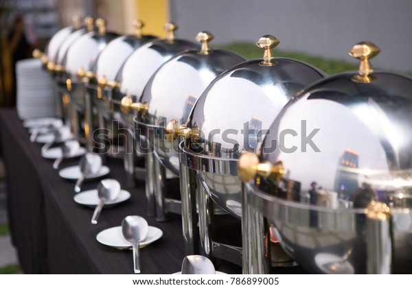 Chafing dishes\
on the table at the luxury\
banquet