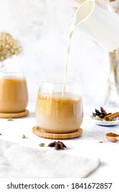 Chai Latte pouring shot. Chai Latte Drink. Pouring oat milk into chai latte glass.  - Shutterstock ID 1841672857