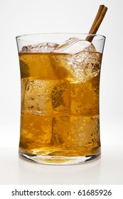 Chai Tea Cocktail Against A White Background With A Cinnamon Stick As A Garnish.