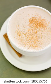 Chai tea latte with cinnamon stick.