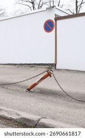 A chain is attached to a fire hydrant and is hanging off the ground