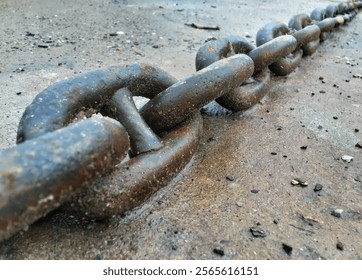 Chain background on sand. Interconnected iron chains. Close-up of the anchor chain