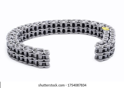 Chain camshaft, on an isolated white background. Car engine timing chain. laid out in the shape of a coliseum
