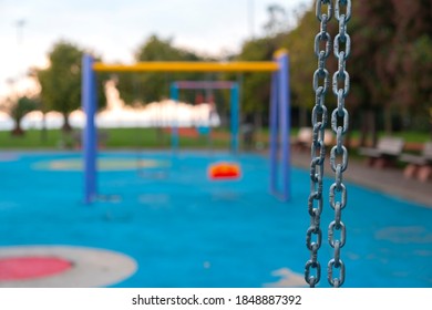 Chain Detail Of The Swing In The Children's Playground Empty Kids Park In The Background