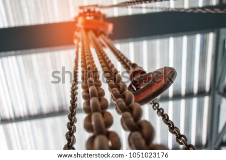 Chain Hoist. Industrial hook hanging on reel chain .