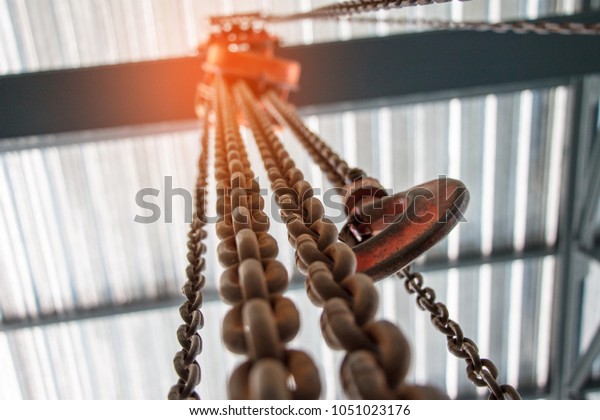 Chain\
Hoist. Industrial hook hanging on reel chain\
.