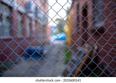 A chain link fence blocks access to an alleyway or laneway between two brick warehouses in Carnegie, Melbourne, Australia. - Powered by Shutterstock