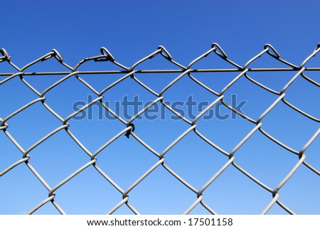 Chain link fence with blue sky background