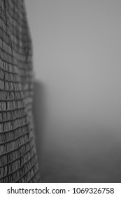 Chain Link Fence In A Foggy Alleyway 