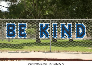 Chain link fence with a positive motivational message - Powered by Shutterstock