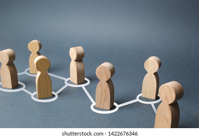 Chain of people figurines connected by white lines. Cooperation and interaction between people and employees. Dissemination of information in society, rumors. Communication. social contacts - Shutterstock ID 1422676346